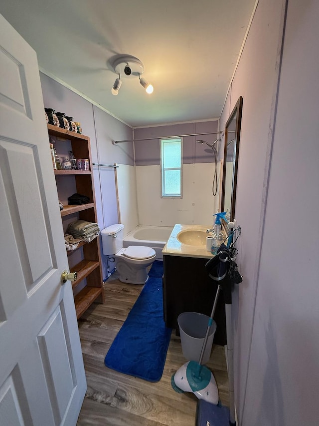 bathroom with toilet, vanity, bathtub / shower combination, and wood finished floors