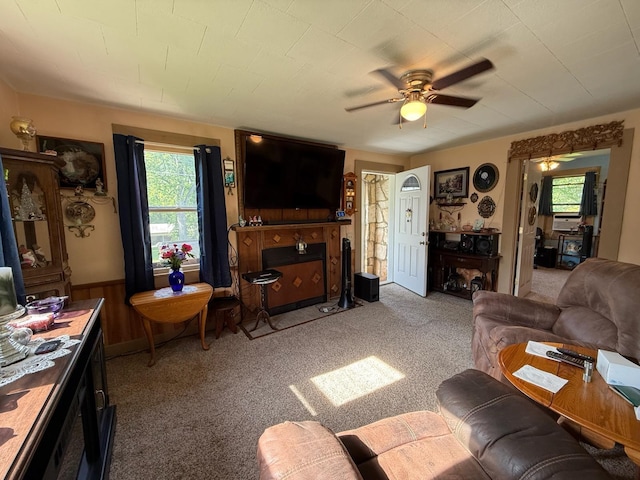 living room featuring light carpet, a ceiling fan, and plenty of natural light