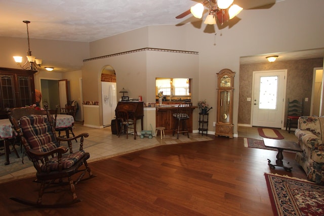 289 Frog Pond Rd, Seymour, MO 65746 - living area featuring baseboards, light wood-style flooring, high vaulted ceiling, and ceiling fan with notable chandelier