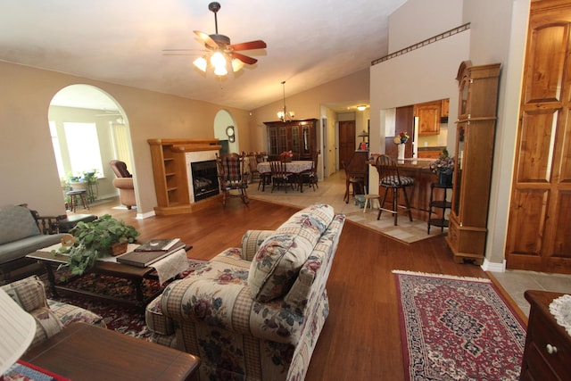289 Frog Pond Rd, Seymour, MO 65746 - living room featuring arched walkways, lofted ceiling, a ceiling fan, and light wood-style floors