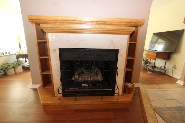 289 Frog Pond Rd, Seymour, MO 65746 - interior details featuring baseboards, a tiled fireplace, and wood finished floors