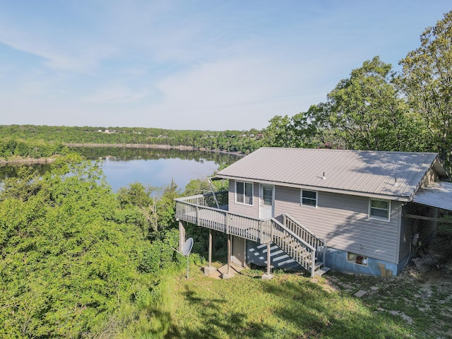 25454 Tulip Pl, Urbana, MO 65767 - rear view of house with stairs, metal roof, a view of trees, and a deck with water view
