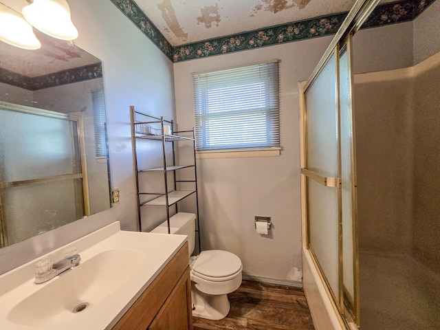 25454 Tulip Pl, Urbana, MO 65767 - bathroom with toilet, baseboards, shower / bath combination with glass door, vanity, and wood finished floors