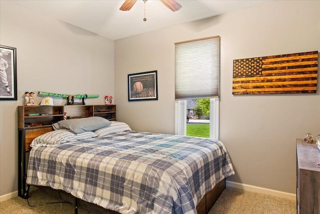 carpeted bedroom with ceiling fan and baseboards