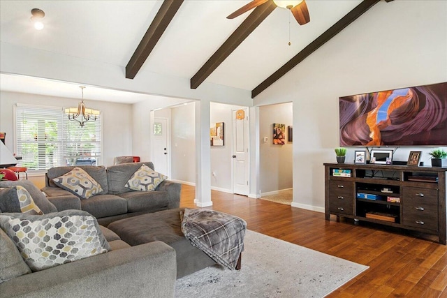 living room with dark wood finished floors, baseboards, ceiling fan with notable chandelier, and vaulted ceiling with beams