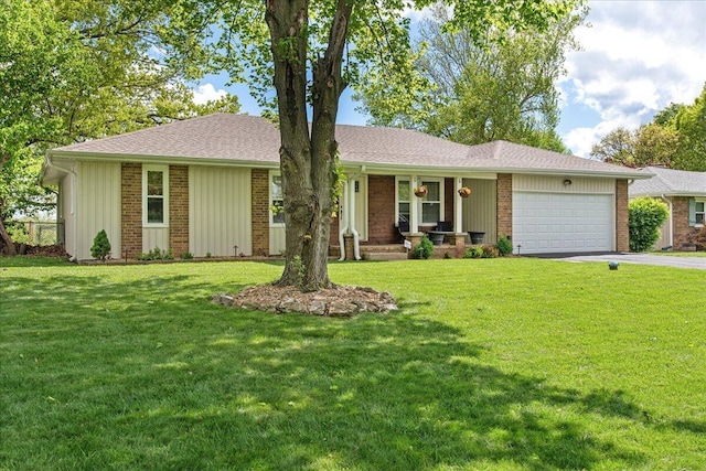 ranch-style home featuring covered porch, a front yard, a garage, and driveway