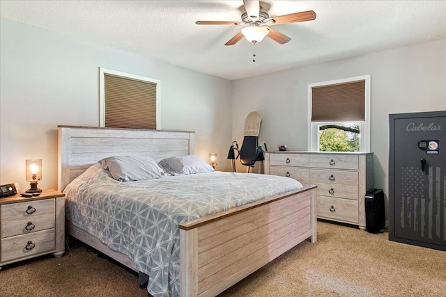 bedroom featuring a ceiling fan and light colored carpet