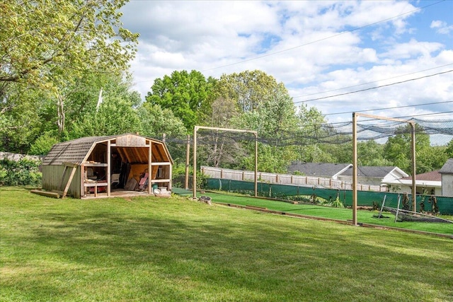 view of jungle gym with a storage shed, a yard, fence, and an outbuilding