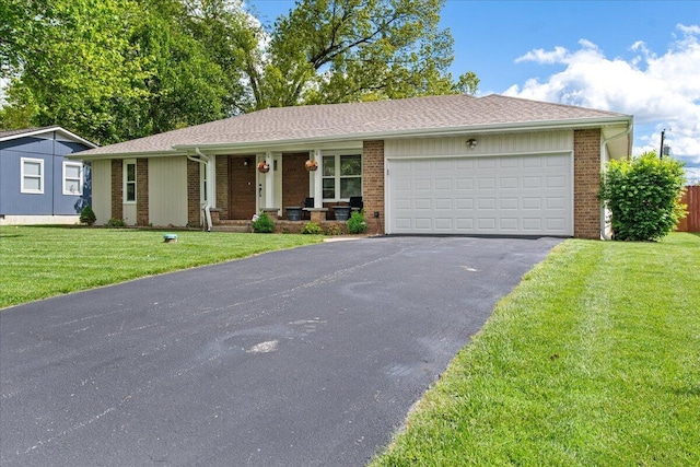 ranch-style house with covered porch, aphalt driveway, brick siding, a garage, and a front yard