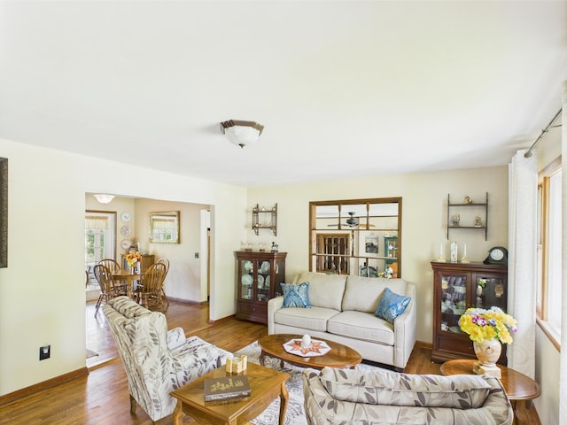 living area featuring baseboards and wood finished floors
