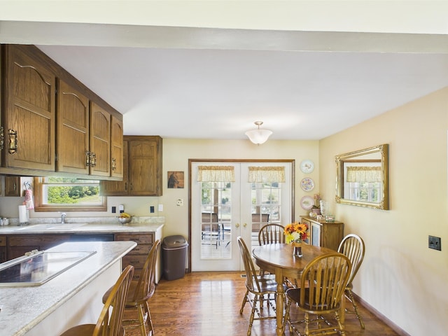 dining space with french doors and wood finished floors