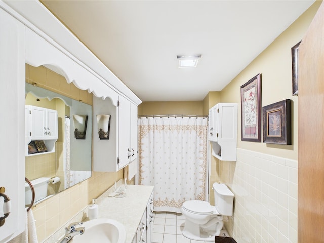 bathroom with tile walls, toilet, a shower with shower curtain, tile patterned flooring, and vanity