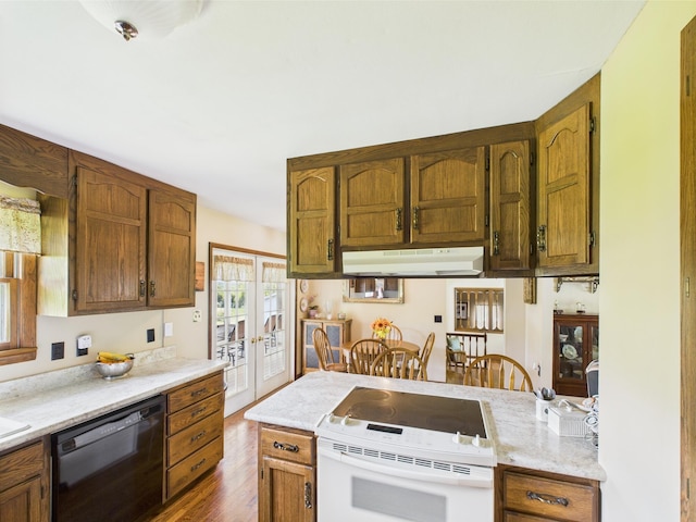 kitchen featuring french doors, electric range, dark wood-type flooring, under cabinet range hood, and dishwasher