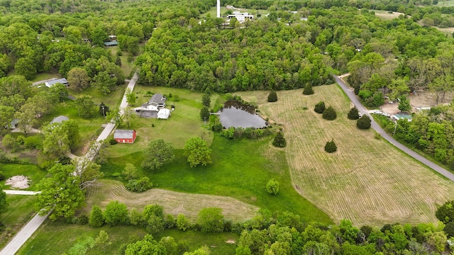 bird's eye view with a wooded view