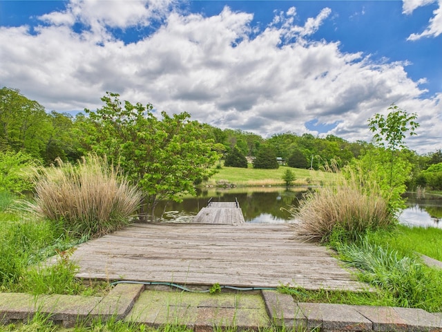dock area featuring a water view and a wooded view