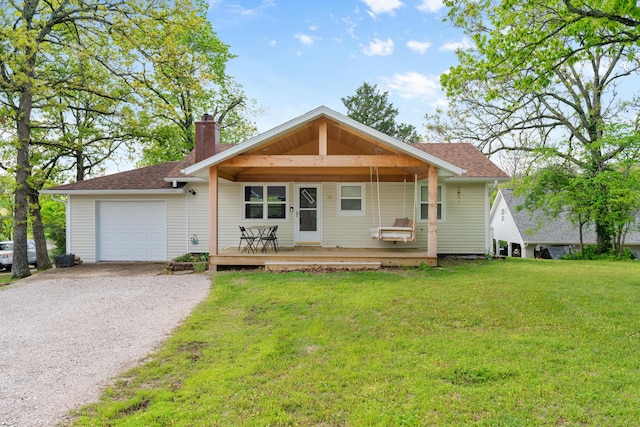 ranch-style home featuring a garage, a chimney, a front lawn, a shingled roof, and driveway