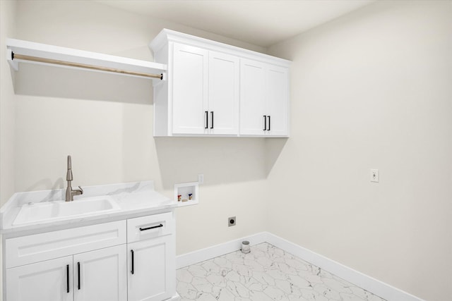 washroom featuring washer hookup, light marble finish floors, electric dryer hookup, cabinet space, and baseboards