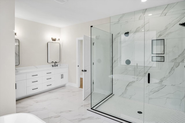 bathroom featuring a marble finish shower, marble look tile flooring, double vanity, a freestanding tub, and baseboards
