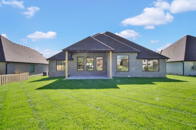 back of property with a patio area, brick siding, and central air condition unit