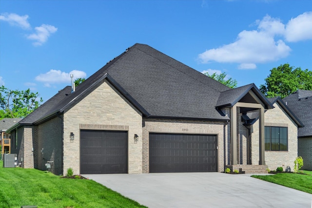 french country style house with an attached garage, driveway, cooling unit, a front yard, and stone siding