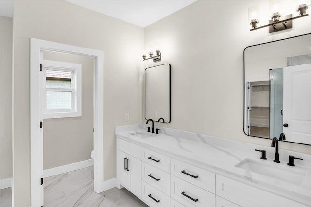 bathroom with marble look tiles, baseboards, double vanity, and toilet