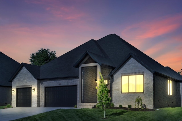 ranch-style house with a garage, stone siding, driveway, and brick siding