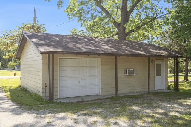 detached garage with a wall mounted air conditioner