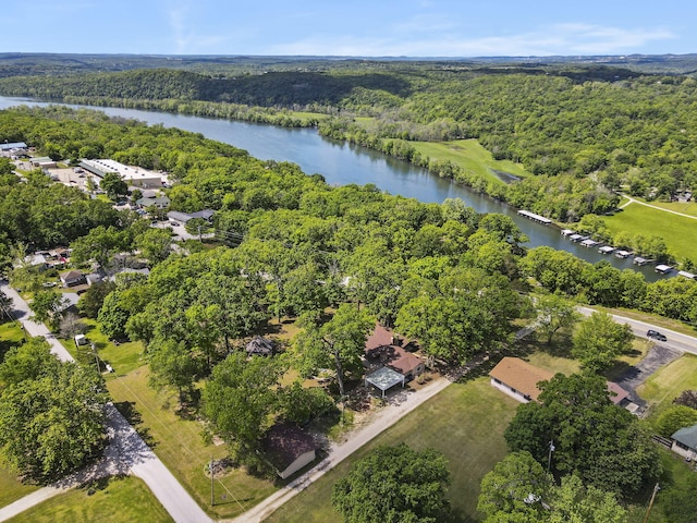 bird's eye view featuring a wooded view and a water view