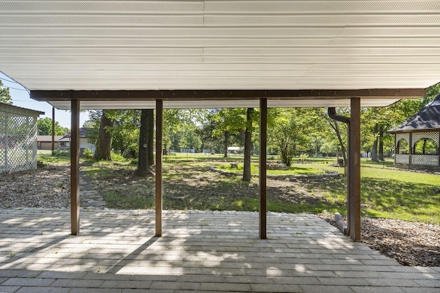 wooden deck with a lawn, a patio, and fence