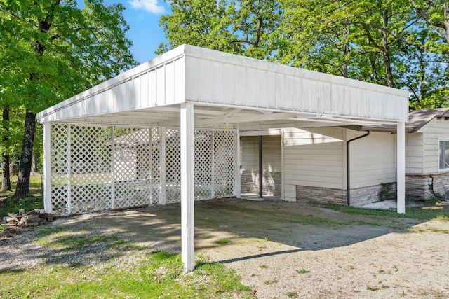 view of vehicle parking featuring driveway and a detached carport