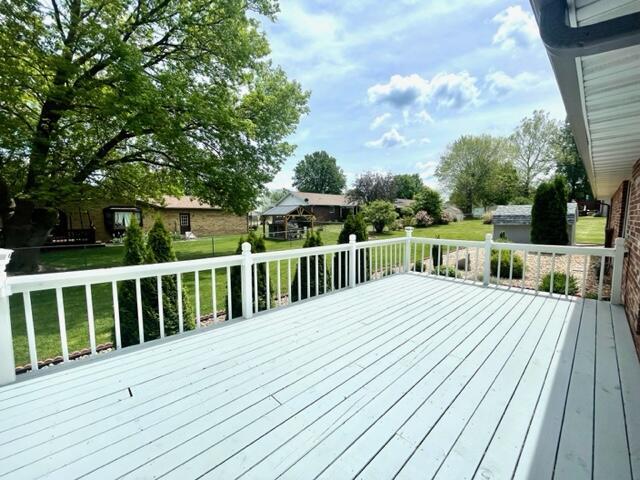 wooden terrace with a lawn