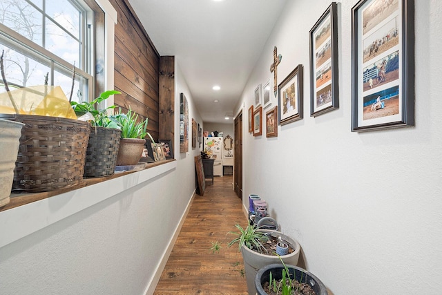 hall featuring wood finished floors, baseboards, and recessed lighting