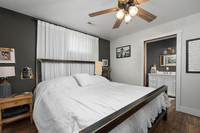 bedroom featuring a ceiling fan, baseboards, visible vents, and wood finished floors