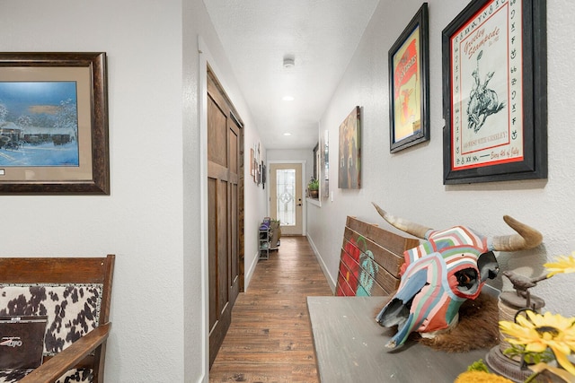 corridor with recessed lighting, baseboards, and wood finished floors