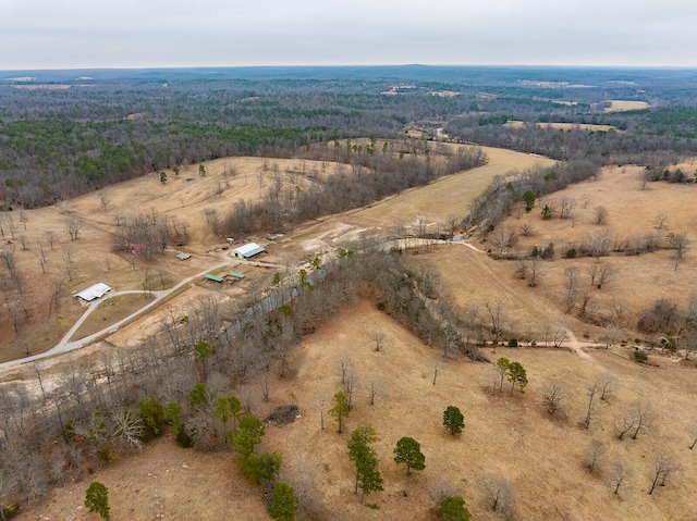 aerial view featuring a wooded view and a rural view