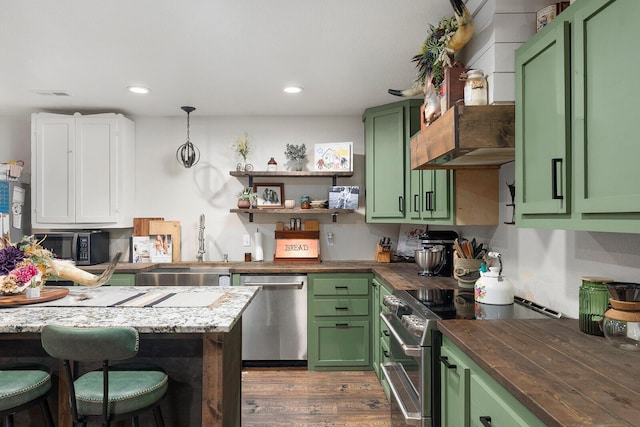 kitchen with appliances with stainless steel finishes, green cabinetry, and a sink