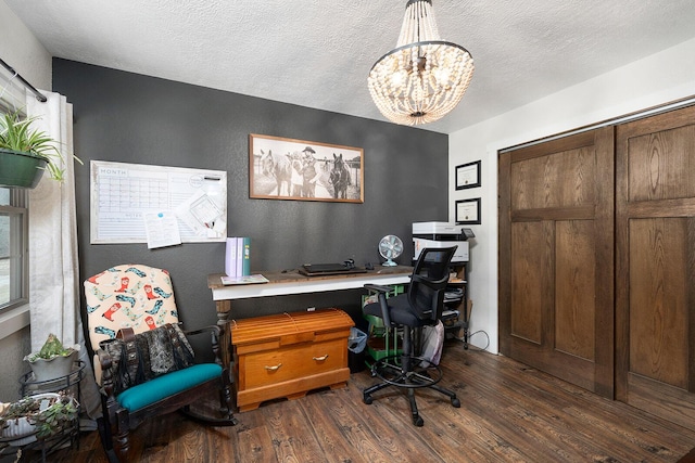 office featuring dark wood-style flooring, a textured ceiling, and a notable chandelier