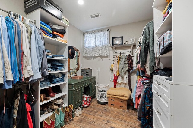 spacious closet featuring visible vents and wood finished floors