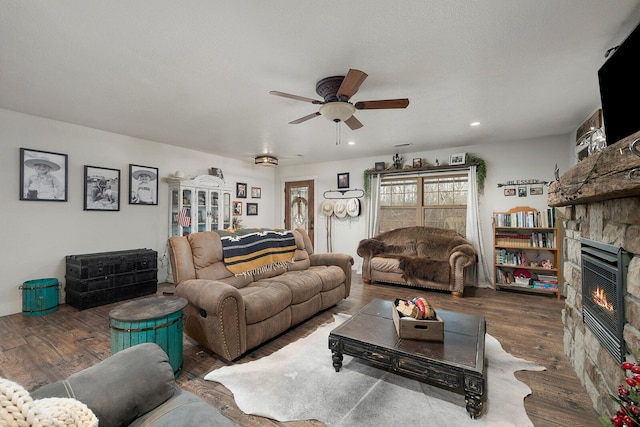 living room featuring a fireplace, recessed lighting, a ceiling fan, and wood finished floors