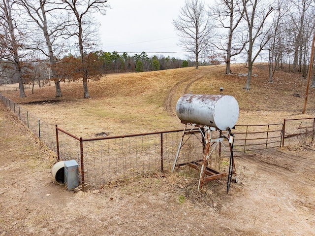 view of property's community with a rural view and fence