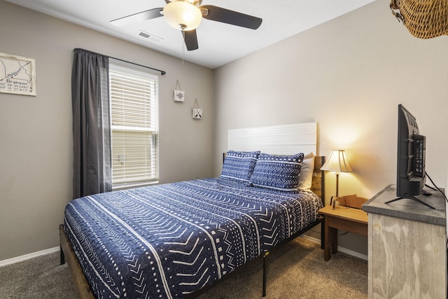 carpeted bedroom featuring baseboards, a ceiling fan, and visible vents