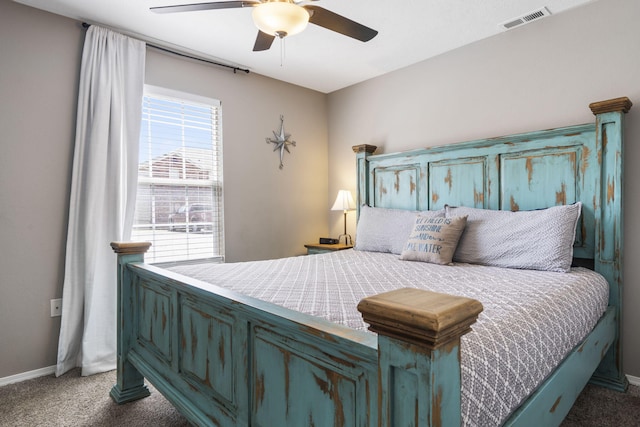 carpeted bedroom featuring baseboards, a ceiling fan, and visible vents