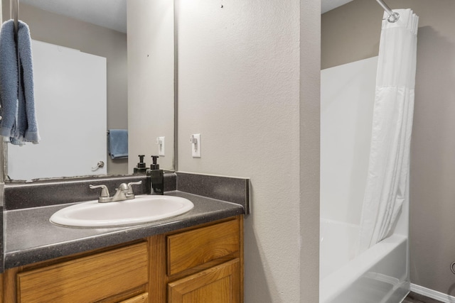 full bathroom featuring shower / bath combo with shower curtain and vanity