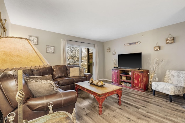 living area featuring wood finished floors and baseboards