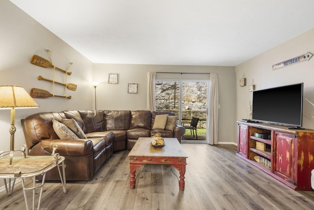 living area featuring wood finished floors and baseboards