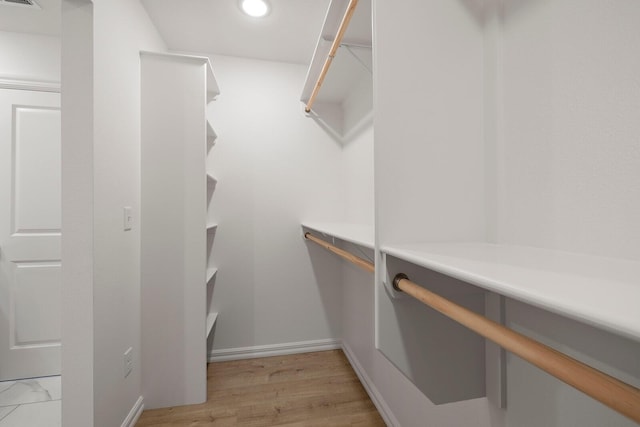 walk in closet with visible vents and light wood-type flooring