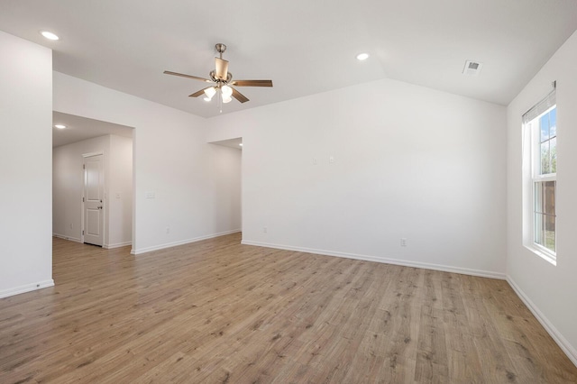 spare room with a ceiling fan, visible vents, light wood-style floors, vaulted ceiling, and recessed lighting