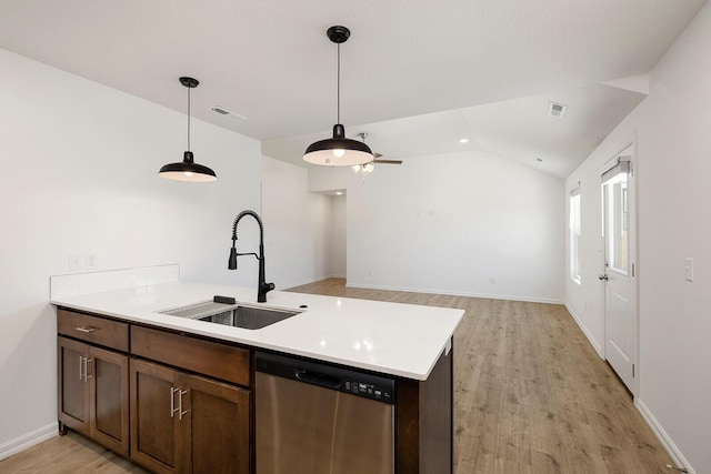 kitchen featuring light wood-style flooring, dishwasher, visible vents, a sink, and light countertops