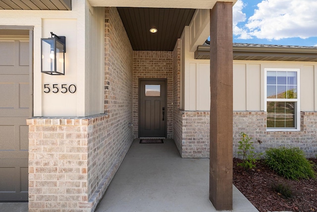 entrance to property featuring brick siding