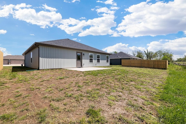 back of property with a patio, fence, and a lawn